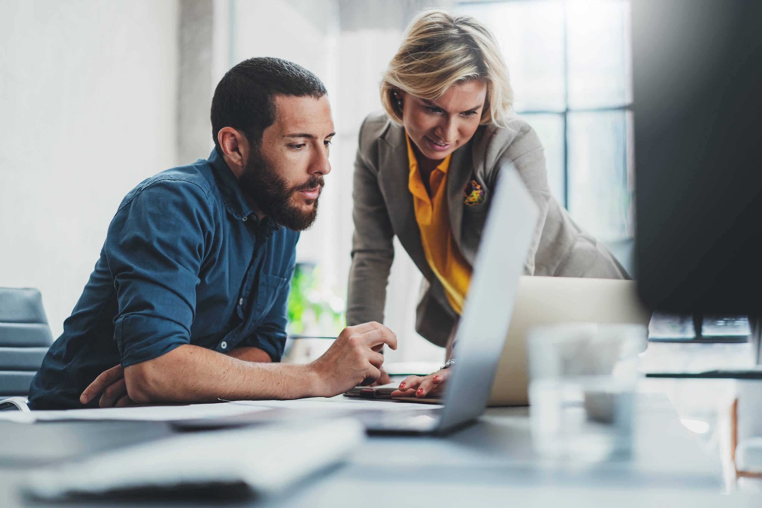 Man and woman looking at loan on computer