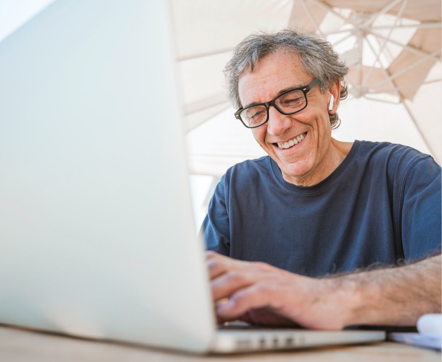 older man working on laptop