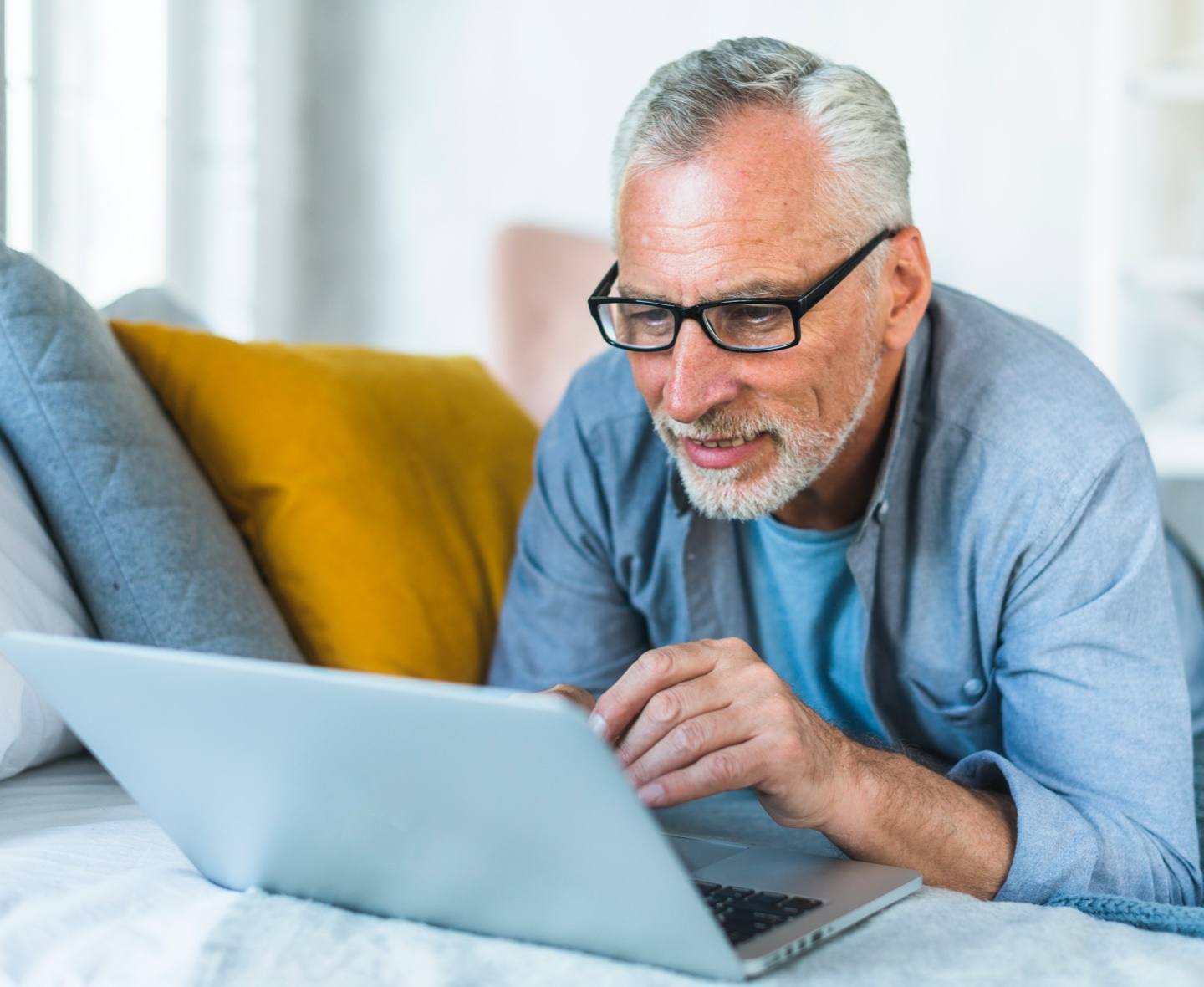 older man working on laptop