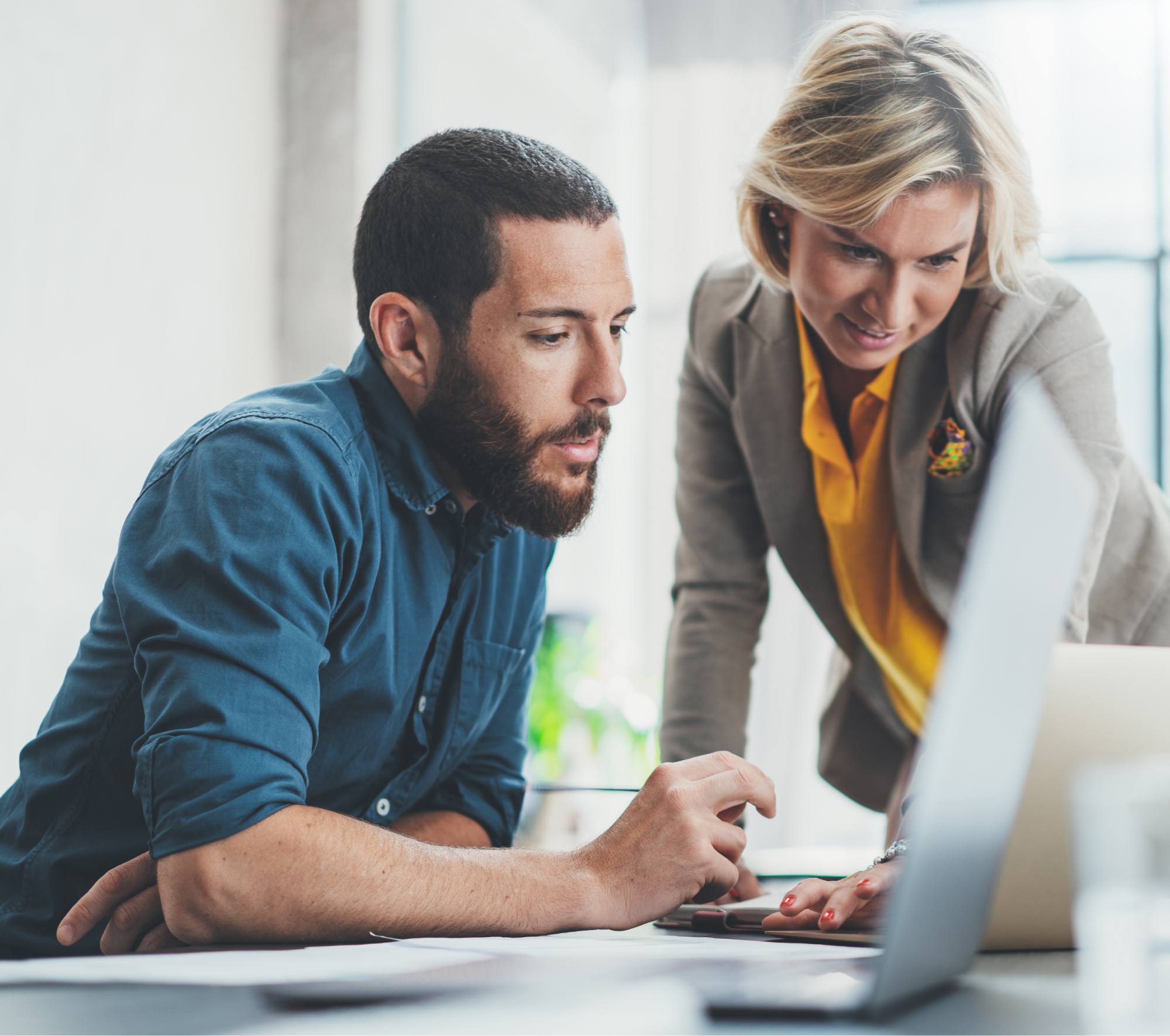 man and woman looking at laptop